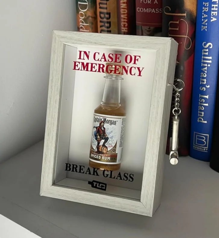 White Emergency Break Glass Display Box on bookshelf